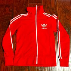 Adidas Originals Women's Trainer Jacket. Polyester Blend. Fitted. Like New, Never Worn. Orange/Red Color. Retro Style. Great Jacket! Adidas Fitted Long Sleeve Outerwear, Fitted Long Sleeve Adidas Outerwear, Spring Adidas Fitted Track Jacket, Adidas Fitted Hooded Outerwear, Adidas Fitted Track Jacket For Spring, Fitted Adidas Winter Track Jacket, Adidas Fitted Outerwear For Fall, Fitted Adidas Track Jacket For Winter, Fitted Red Track Jacket For Winter