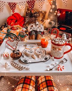 a white tray topped with lots of food and candy canes on top of a table