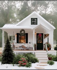 a small white house with christmas decorations on the front porch