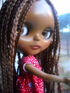 a close up of a doll with braids on it's head and eyes