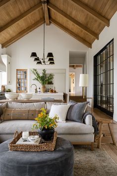 a living room filled with furniture and a wooden ceiling