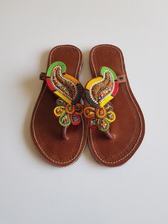 Maasai sandals made with high quality black leather and colorful fine beads. Perfect for outdoor summer events , beach wear , festivals , African themed events etc. The sandals are true to size. Buy multiple items and pay shipping for one item Only. Back to my shop; https://www.etsy.com/shop/TribalTess?ref=seller-platform-mcnav Sandals Colorful, Christmas Gift Earrings, Horn Earrings, African Earrings, Beaded Sandals, Themed Events, Outdoor Summer, Brown Leather Sandals, Maasai