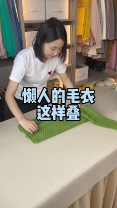 a woman in white shirt and green towel on table