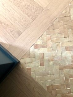 the floor is made out of wood and has a herringbone pattern on it's side