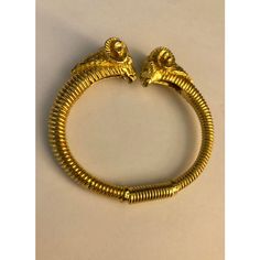 This Vintage Kenneth Jay Lane Rams Head Gold Clamper Bracelet is a traditional piece of vintage jewelry that will go with anything, day or night. The detail on the heads of the ram and the "coiled" design of the bangle make this a clamper bracelet a true standout!  Dimensions: 2.75"L x 2.5"W x .5"D Condition: Excellent vintage condition; very little wear. Please see pics for details. Marks: KENNETH © LANE  About Kenneth Jay Lane: For nearly 60 years, Kenneth Jay Lane (April 22, 1932 – July 20, 2017) was one of the most famous costume jewelry designers in the world. Lane was named, “the undisputed King of Costume Jewelry” by Time Magazine. Lane was friends with, beloved by, and worn by celebrities, royals, first ladies, and socialites such as Jackie Kennedy, Babe Paley, Elizabeth Taylor, Th Babe Paley, Sapphire Bangle, Modern Bangle, 18k Gold Bangle, Rams Head, Red Bangles, First Ladies, Plastic Bangles, Ram Head