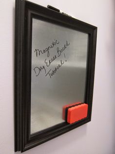 a magnetic dry eraser mounted to the side of a mirror