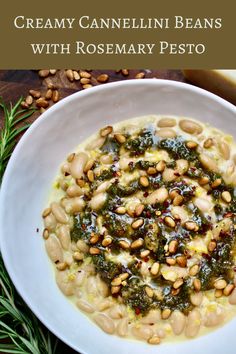 creamy cannellini beans with rosemary pesto in a white bowl on a wooden table