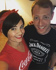 a man standing next to a woman wearing a bandana on top of her head