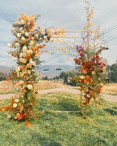 an outdoor wedding setup with flowers on it