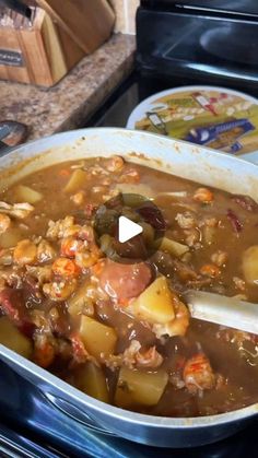 a pot filled with stew and vegetables on top of a stove