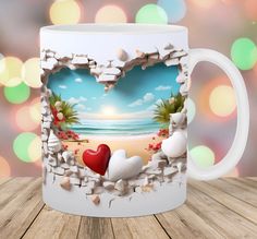 a coffee mug with two hearts on the beach in front of a colorful boke