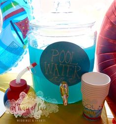 there is a pool water bucket and cups on the table