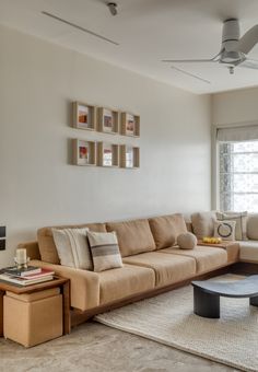 a living room filled with furniture and a flat screen tv mounted to the side of a wall