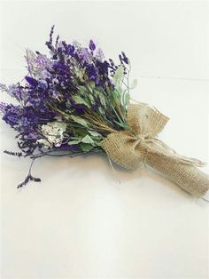 a bunch of purple flowers tied to a burlock