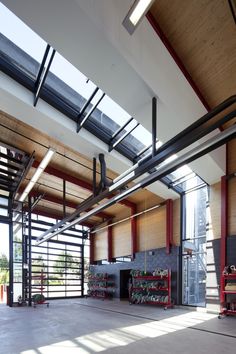 the inside of a large building with lots of windows and metal pipes on the ceiling