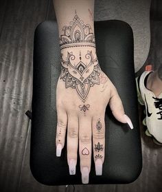 a woman's hand with tattoos on it