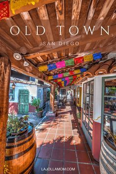 an old town with colorful flags hanging from it's roof and the words, old town san diego