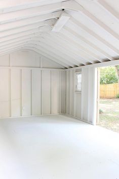 an empty garage with white walls and ceiling