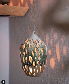 a decorative light fixture hanging from a wall