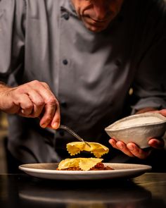 a man is eating food from a plate