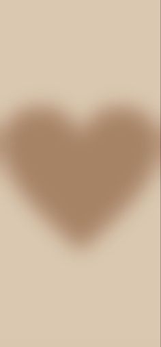 the shadow of a heart shaped object on a beige background is seen in this image