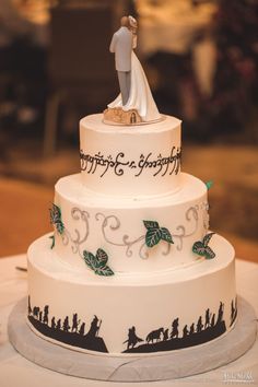 a wedding cake with a bride and groom figurine on top