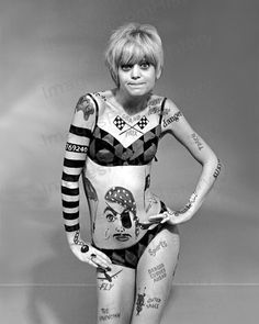 an autographed photo of a woman with tattoos on her arms and chest, in black and white