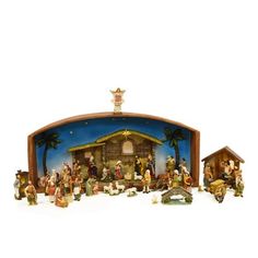 a nativity scene with figurines in the foreground and on the right