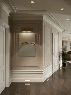 an empty room with wood floors and white walls, painted in neutral colors on the walls