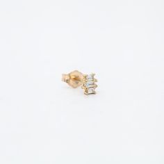 Jennie Kwon's tiny but beautifully dimensional baguette stud is easily worn on her own, but also plays well with others. It shimmers splendidly with not one but three diamonds and captures the eye with its tantalizing sparkle. 14 karat gold set with one 3 x 1.5 mm baguette and two 2 x 1.25 mm baguettes. Please note this style is sold as an individual piece. For a matched pair, please purchase two pieces. Gift Diamond White Baguette Diamond Earrings, Gift Diamond White Earrings With Baguette Diamonds, Fine Jewelry Baguette Diamond Earrings As A Gift, Baguette Diamond Earrings As Gift, Yellow Gold Diamond Earrings With Baguette Diamonds, Timeless Gold Diamond Earrings With Baguette Diamonds, Baguette Diamond Earrings For Gifting, Gold Emerald-cut Diamond Earrings, Luxury 14k Gold Baguette Diamond Earrings