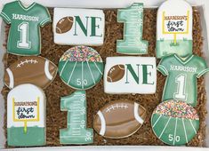 decorated cookies in the shape of footballs and numbers