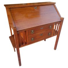 a wooden desk with two drawers on one side and an open drawer on the other