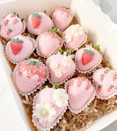 a box filled with pink chocolate covered strawberries