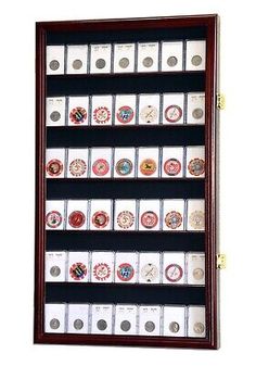 a display case filled with lots of different types of buttons and magnets in it