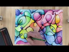 someone is drawing something with colored pencils