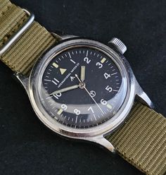 Offered is an IWC Mk 11 wristwatch dating to 1952. This is a rare, desirable and keenly collected watch. It is in working, serviced, condition and is original throughout. Breaking the watch down: Case - 36mm without the crown and 39.6mm with. It is 46.2mm lug to lug. Welded fixed bars. The case is unpolished. As an issued military wristwatch, that means it's got some marks. In fact, there are plenty of scratches as well as a few dings. I will leave it to the next owner to decide whether or not t Pumpkin Colors, Watch Companies, Watch It, Wrist Watches, The Crown, Wrist Watch, Crown, Turn Ons, Music Clothes