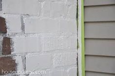 a white brick wall with green trim on it