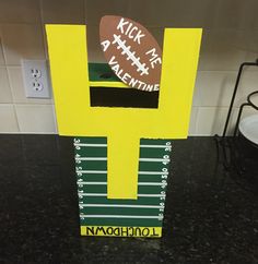 a cardboard football trophy sitting on top of a counter