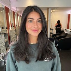 Woman with a gorgeous long layered haircut. Discover the top 10 haircuts that make you look younger and refresh your look in no time! Say hello to a more vibrant, youthful version of yourself with these trendy styles. Get ready to embrace a fresher, more youthful appearance today! Long Layered Hair Not Styled, Dark Long Layered Hair, Medium Long Brunette Haircut, Long Haircut Women Straight, Women’s Haircut Long Layers, Haircuts With No Layers, Easy To Maintain Haircut Long Hair, Girls Long Layered Haircut, All One Length Hair