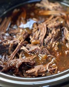 the meat is being cooked in the slow cooker