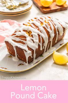 lemon pound cake on a plate with white icing and sliced lemons in the background