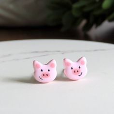 DAINTY pink piggy earrings!  Measures just 7mm approx.  Hand painted tiny details to bring a smile! Titanium posts for sensitive ears and comfy fit.  Earrings are so lightweight you'll forget you're wearing them!  Finished with a beautiful, glossy finish. // Info: * Titanium posts * 100% Nickel-free * Hypoallergenic for sensitive ears * Hand sculpted, ultra lightweight + unique designs! We always include a pair of spare rubber backings with each order. ♥ // Stud earrings by PitterPatterPolymer here: https://www.etsy.com/shop/PitterPatterPolymer?ref=hdr_shop_menu&section_id=15736817 Pig Earrings, Pet Pig, Multiple Earrings, Pet Pigs, Titanium Earrings, 3d Pen, Kid Craft, Earring Cards, Cat Earrings