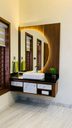 there is a bathroom sink and mirror in the room with wood trimmings on the walls