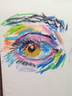 an eye drawn with colored pencils on white paper