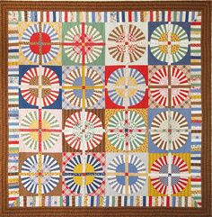 a quilt with many different designs on it