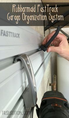 a person is using a garage organization system to attach the door handle on a garage door