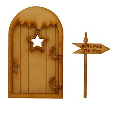 a wooden door with a star on it next to a sign that says north pole this way