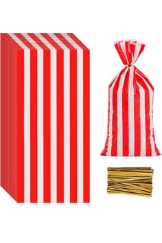 a red and white striped bag next to some matchesticks on a white background