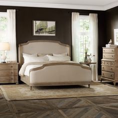 a bedroom with brown walls and white furniture