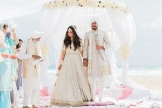 a bride and groom walking down the aisle